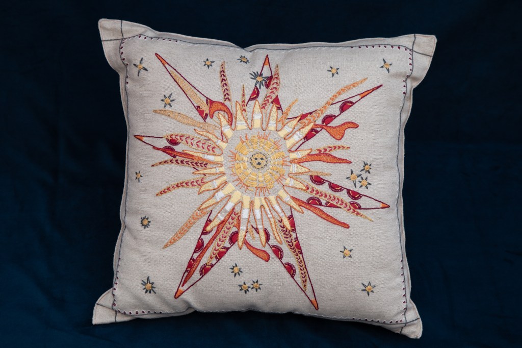 Sun embroidery kit design by artist James Tovey in reds and yellows